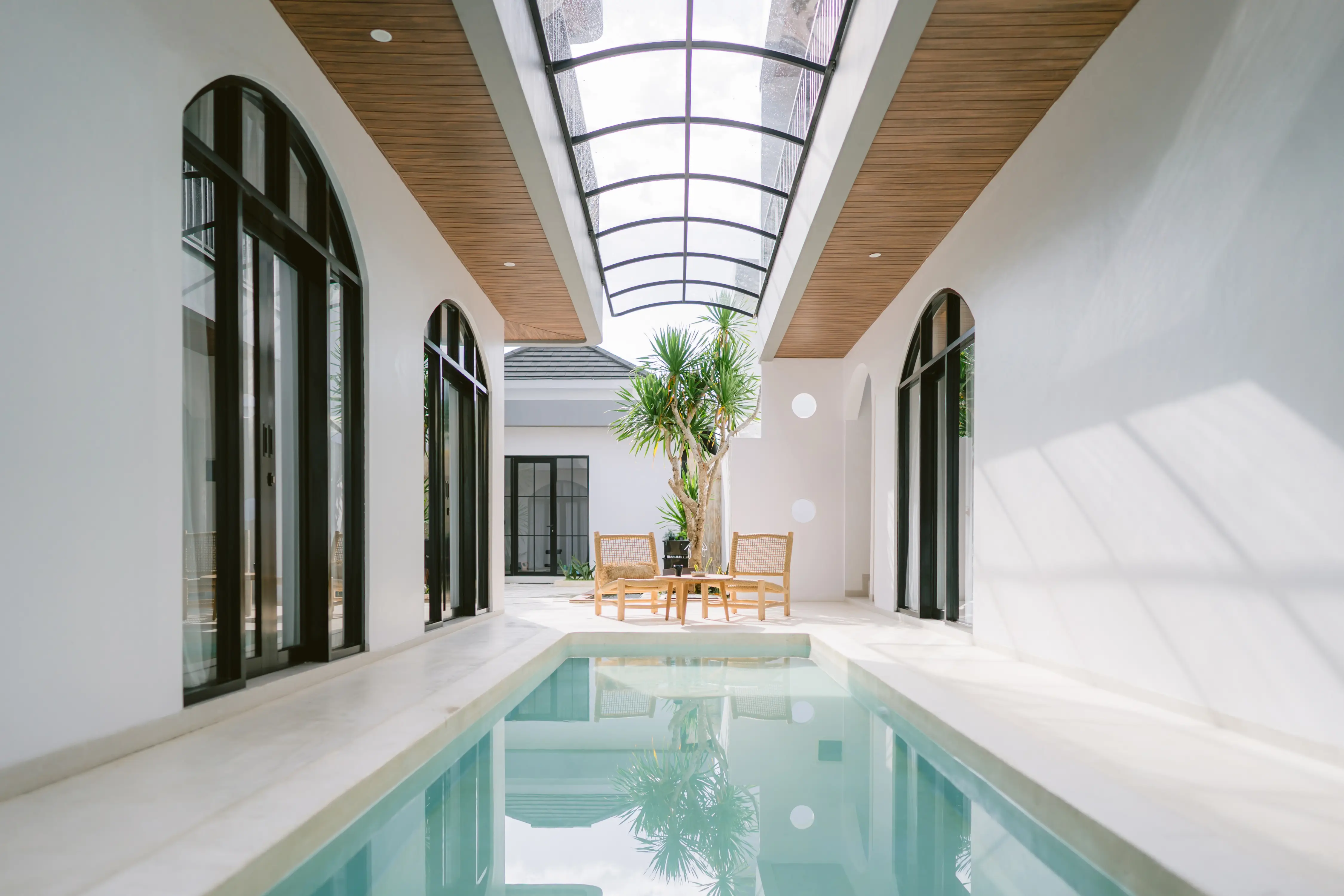 Bedroom with arched grid headboard and full mirror