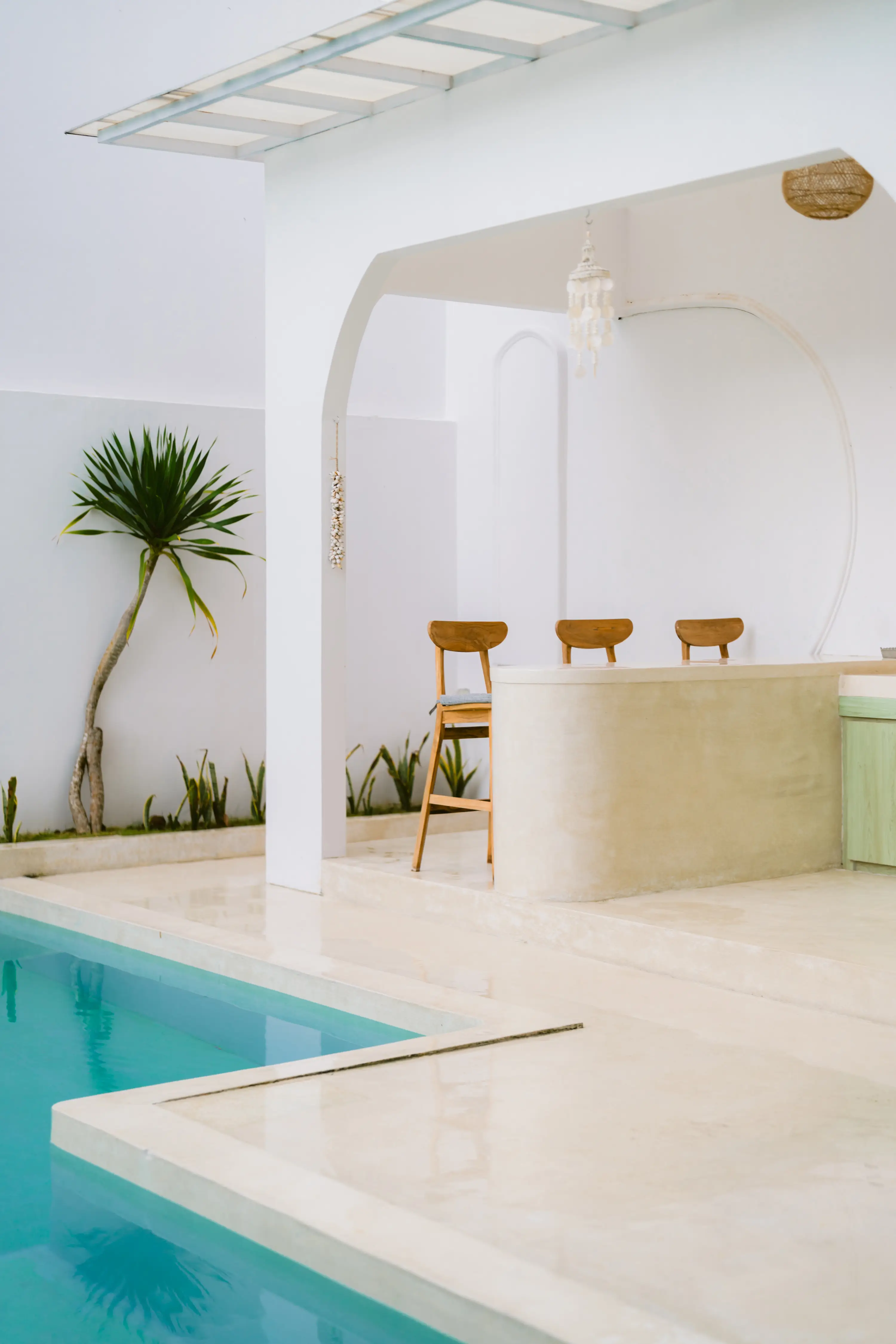 Bathroom with stone vessel sink and round wood-framed mirror