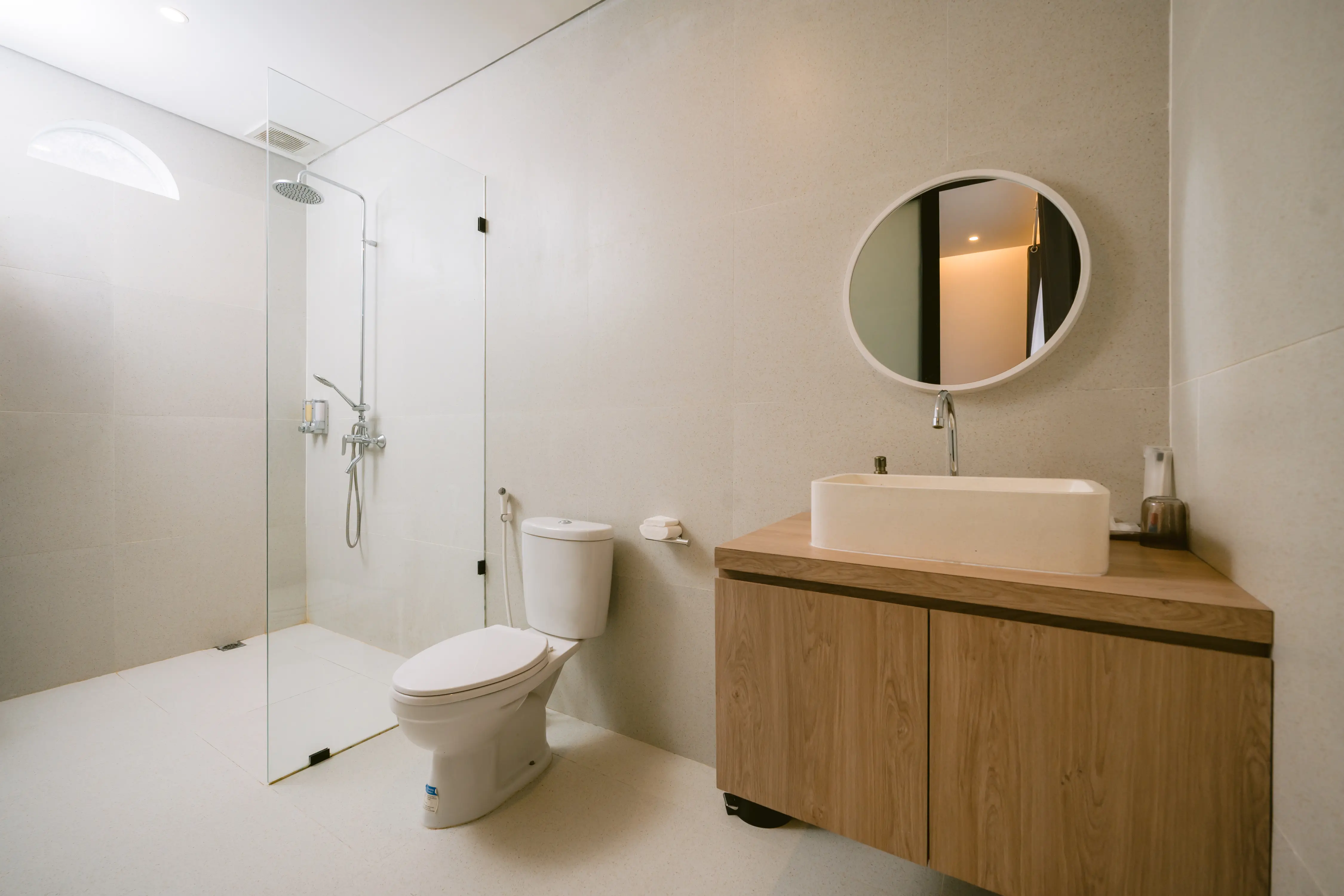 Bathroom with stone vessel sink and round mirror