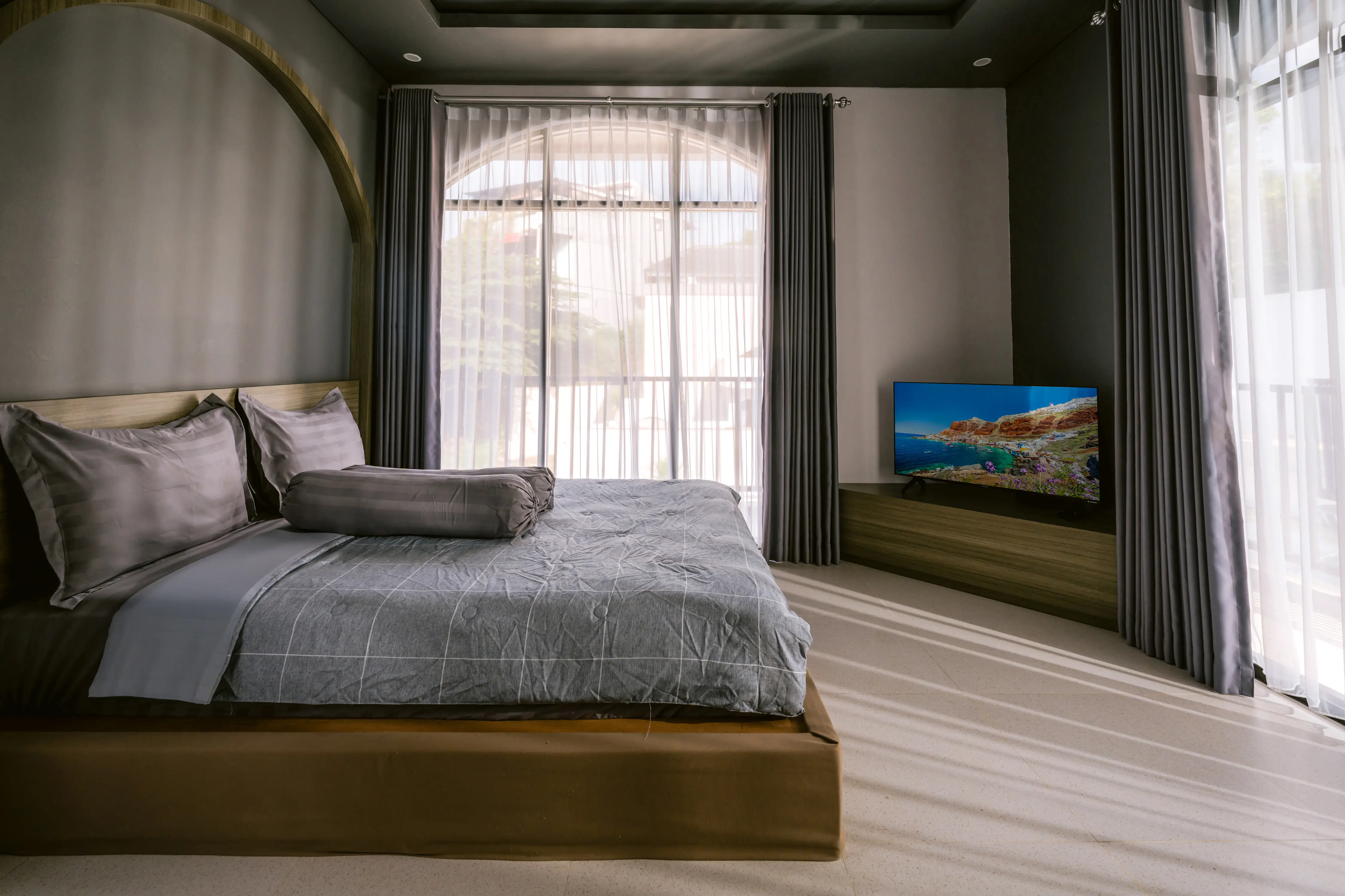 Master bed with TV showing Mediterranean coast