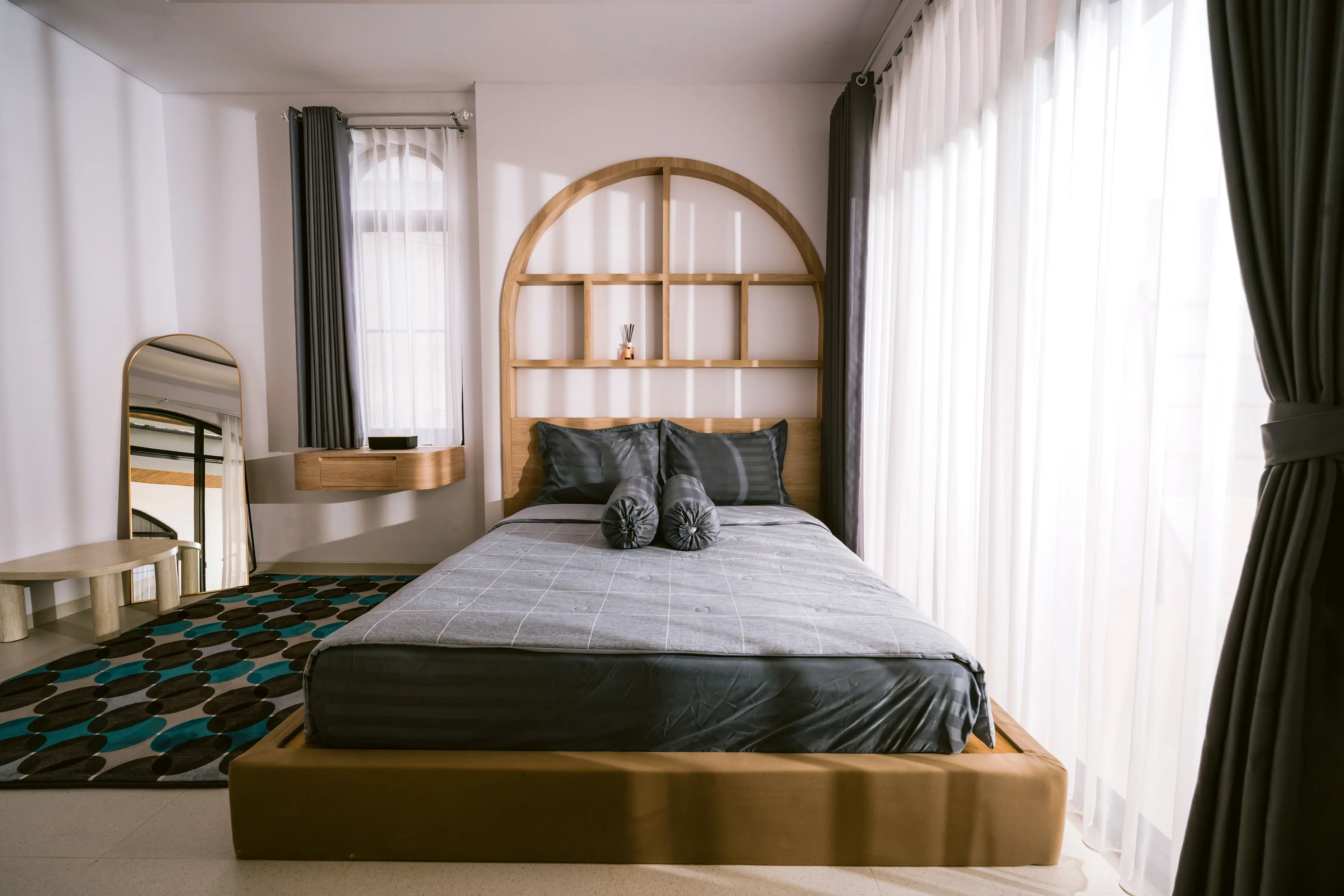 Soleil Suite wide showing arched grid headboard and mirror