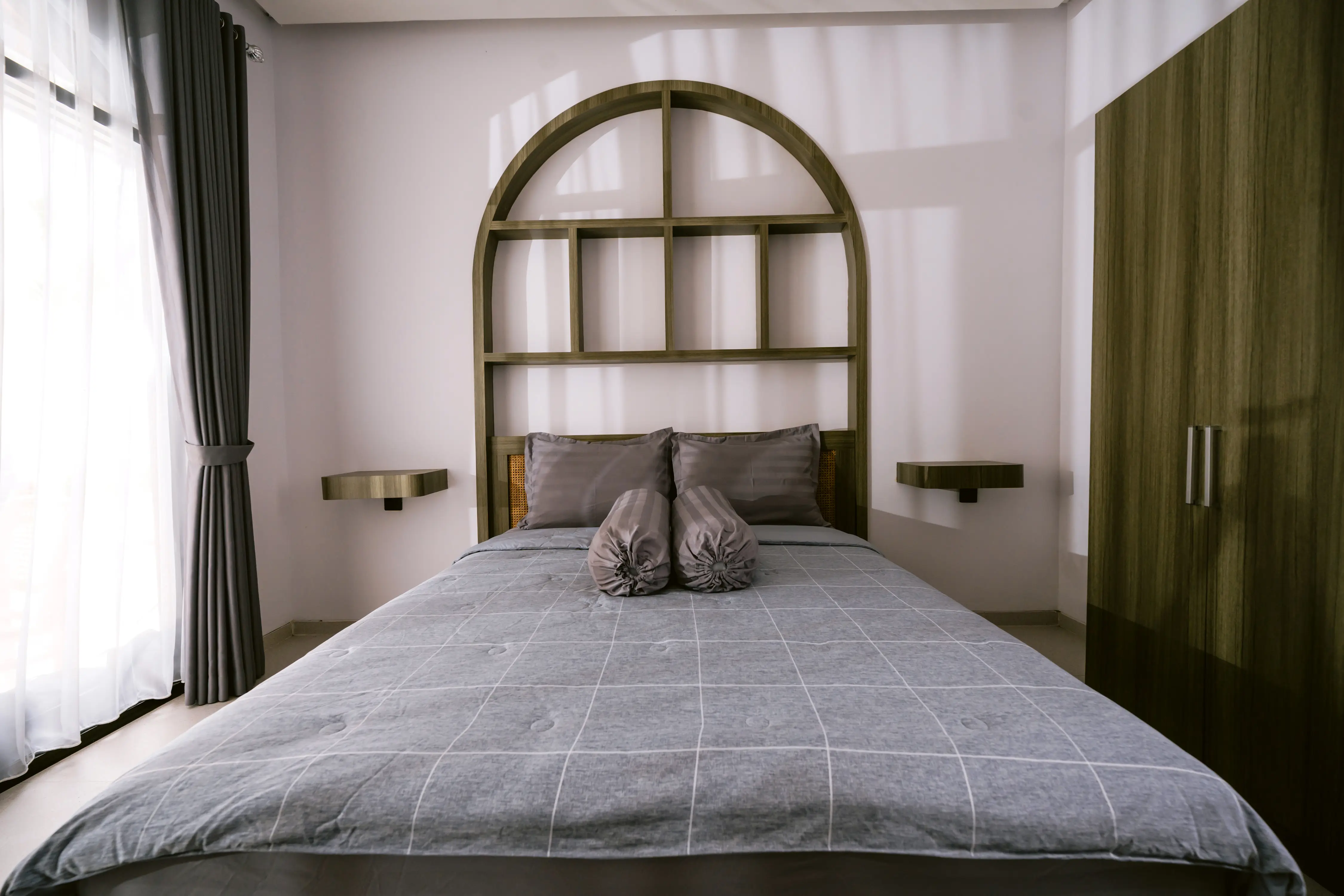 Bedroom warm-lit at golden hour with arched grid