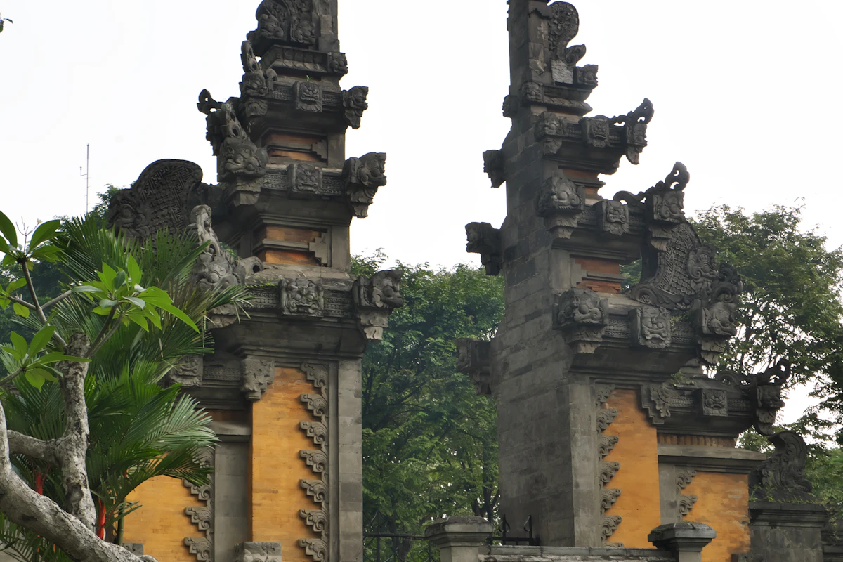A traditional Balinese stone temple with ornamental carvings and statues — accessible cultural experience for families