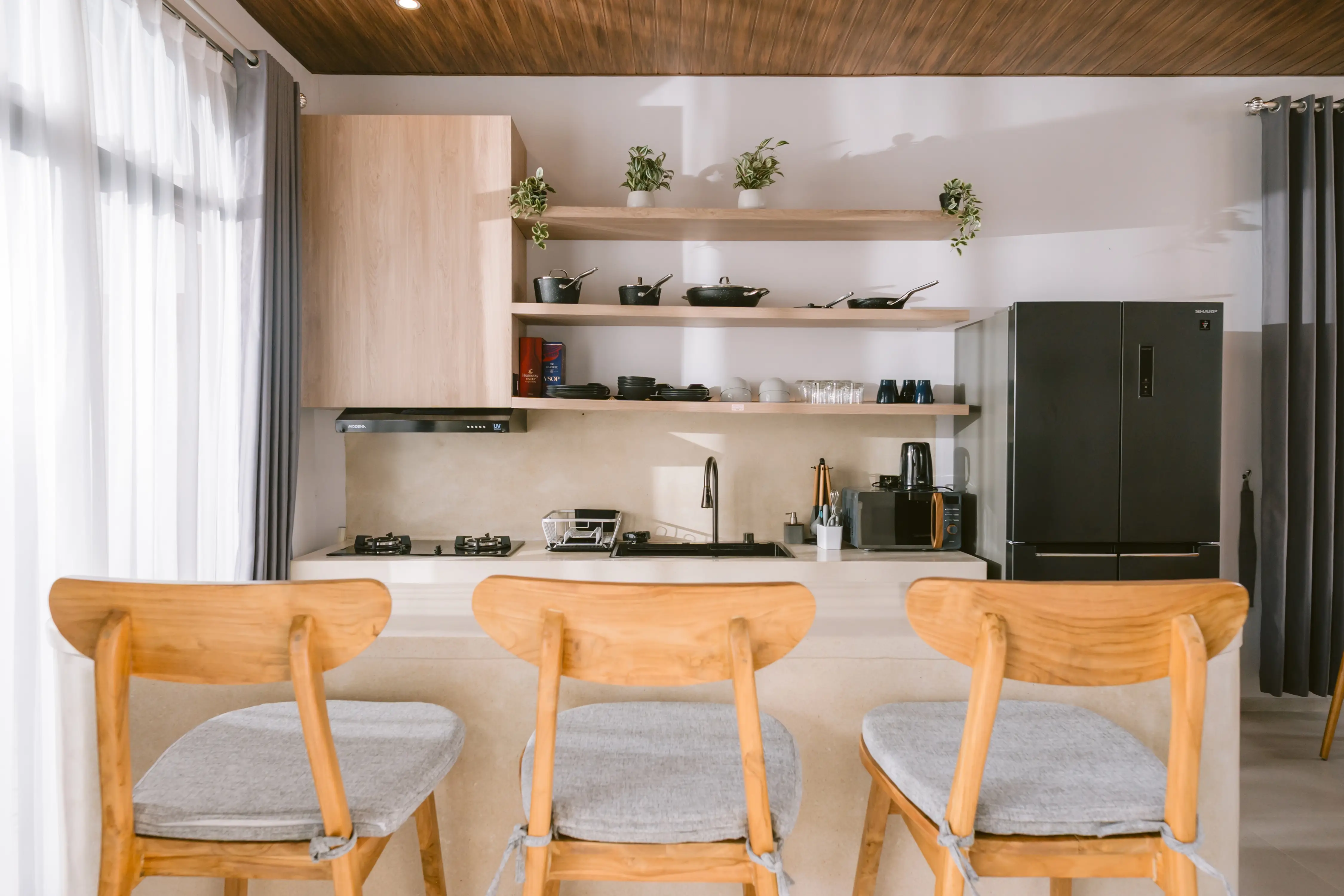 Open kitchen with timber ceiling and breakfast bar