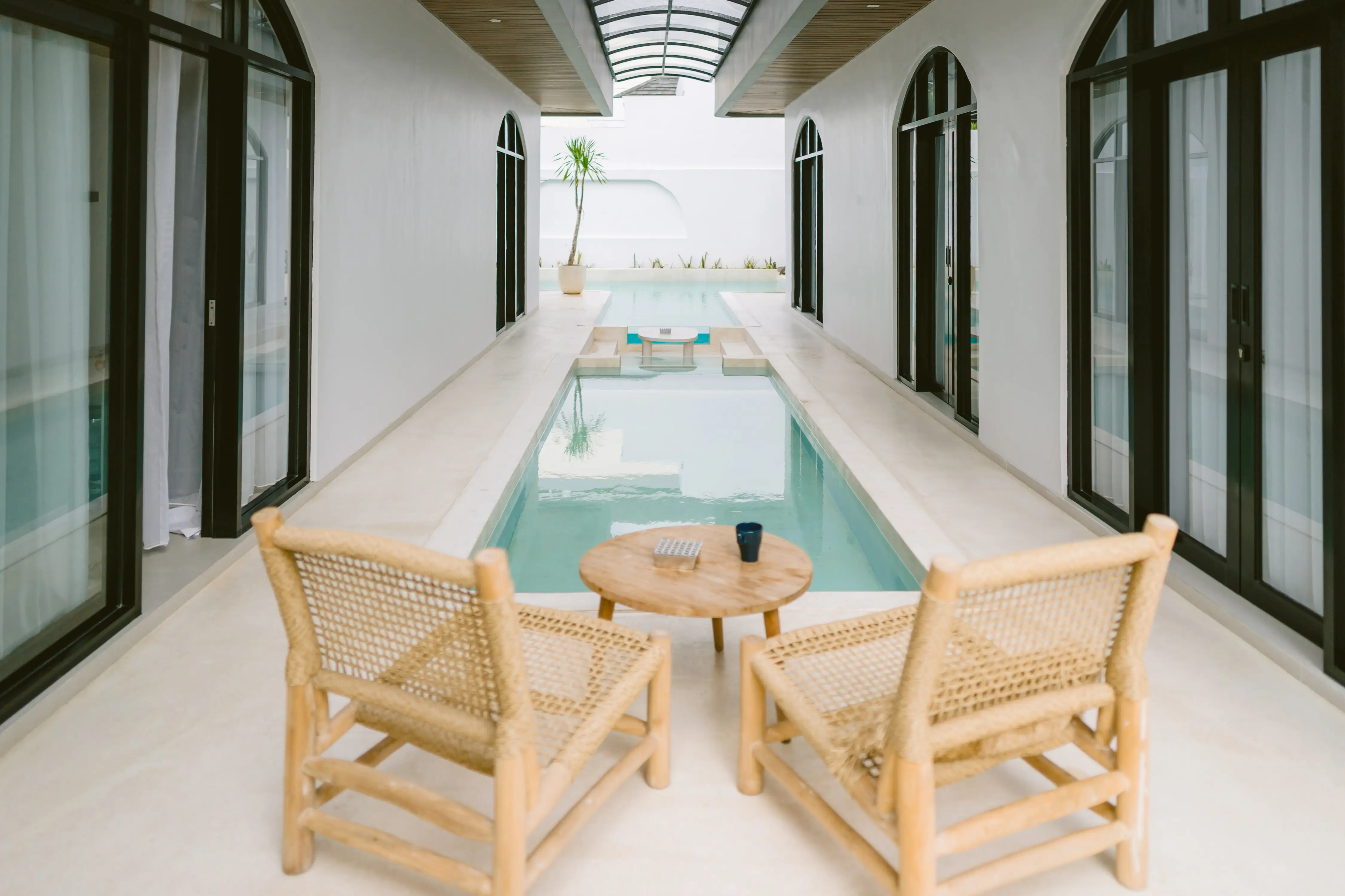 Bedroom with arched grid headboard and full mirror